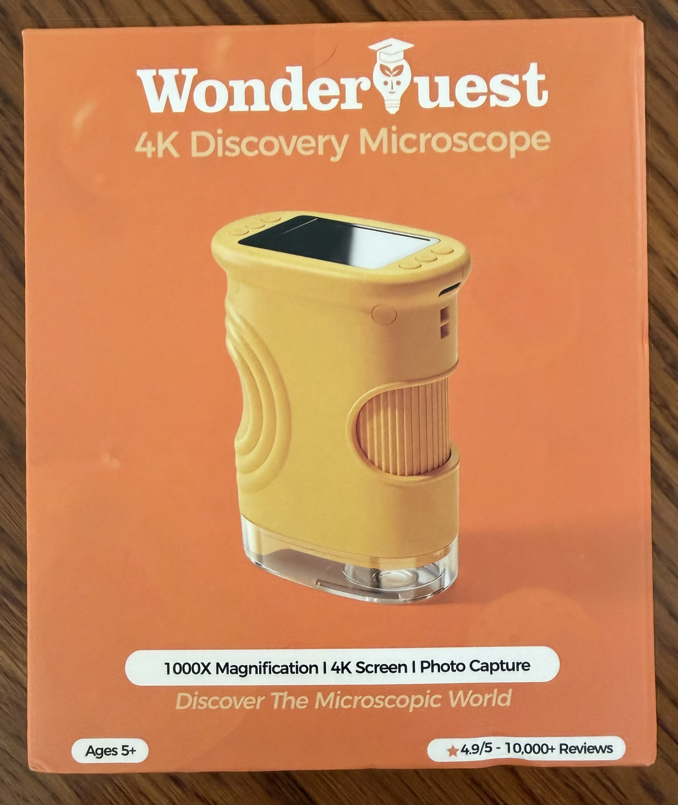 WonderQuest 4K Discovery Microscope retail box front, showing the yellow handheld microscope and "1000X Magnification | 4K Screen | Photo Capture" claims