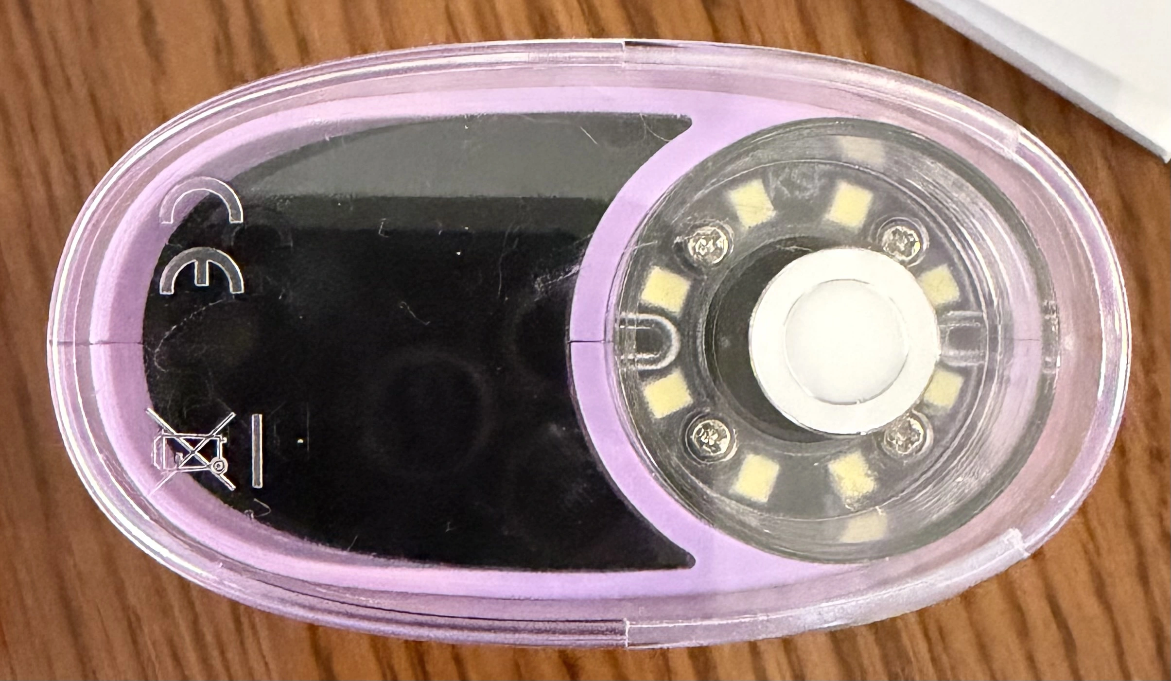 Underside of the WonderQuest microscope showing the lens surrounded by eight LEDs, plus CE and WEEE markings