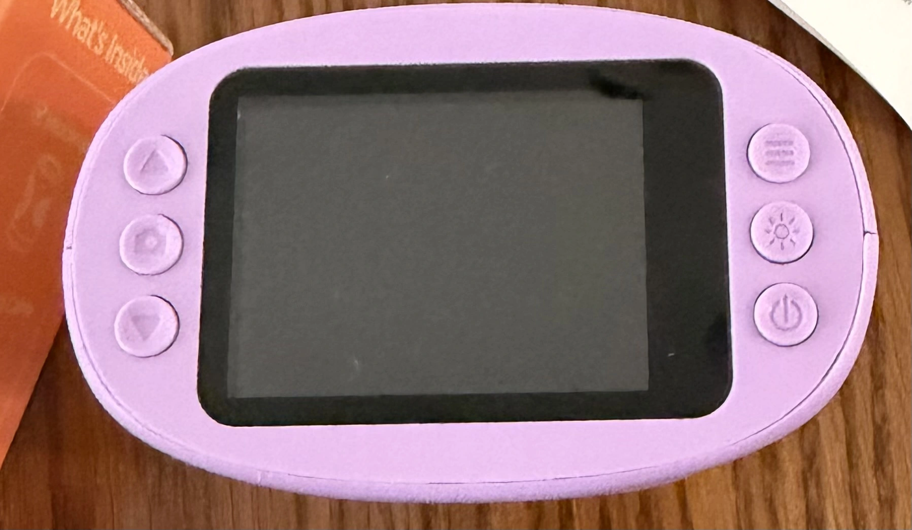 WonderQuest microscope viewed from the top, showing the 2-inch IPS screen flanked by control buttons