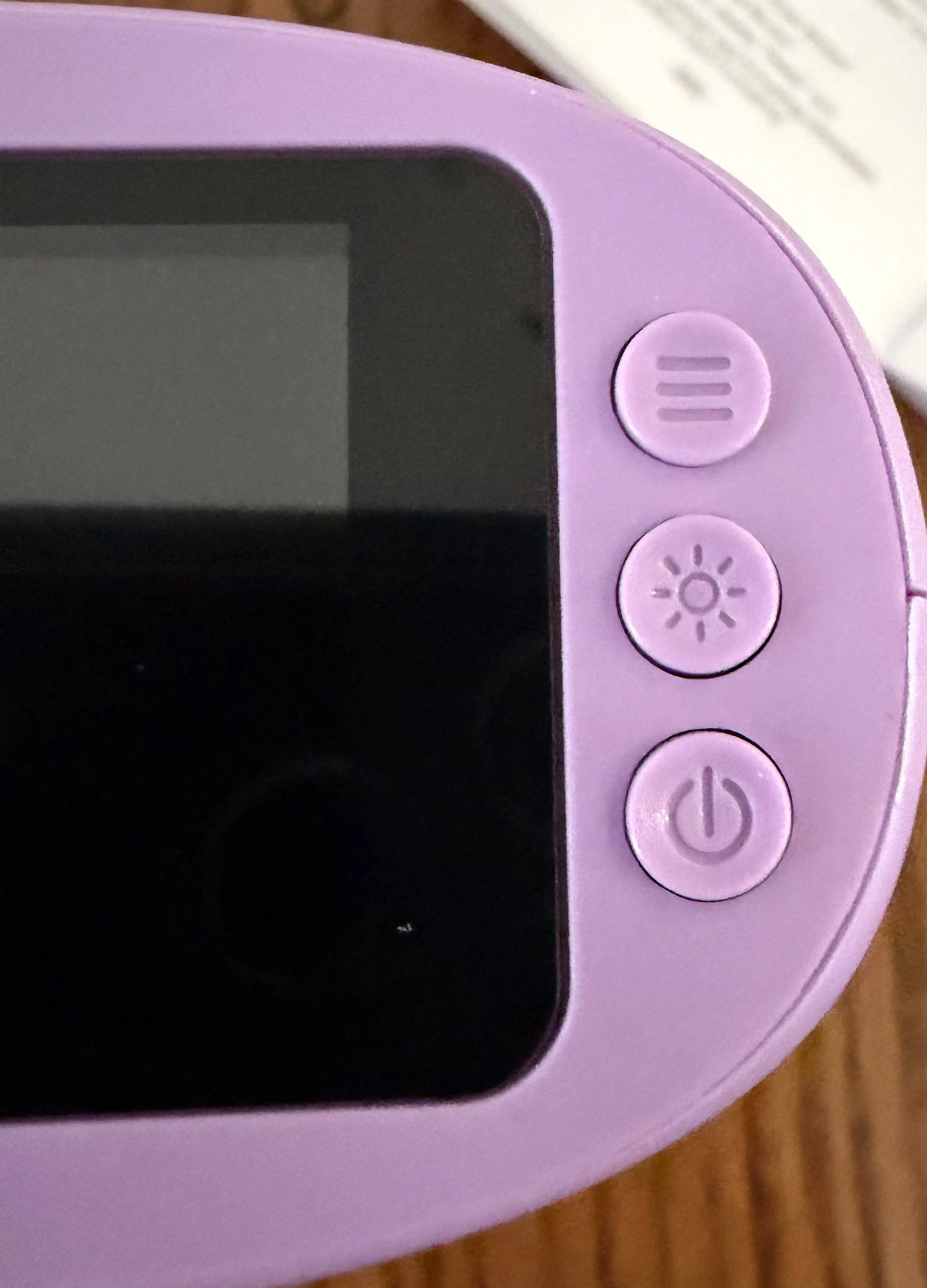 Right-hand buttons on the WonderQuest microscope: review or delete, LED brightness, and power